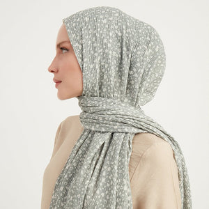 Woman wearing hijab in a side profile, hijab is a Crinkle Cotton Turkish hijab, mint green with small white flowers