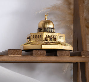 Gold color mini Masjid Aqsa Dome of the Rock table decor piece, sitting on shelf